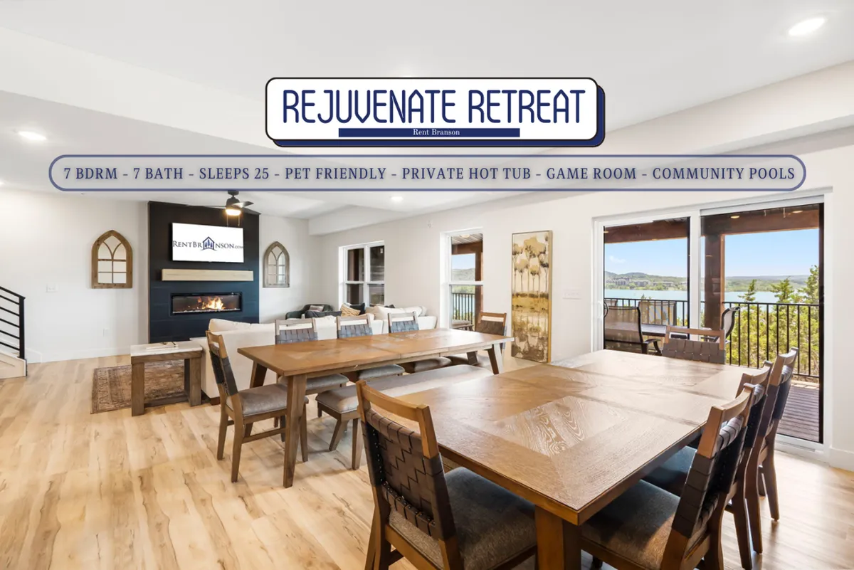 A bright, welcoming living area with a large dining table, a roaring fireplace, and expansive windows offering a scenic view. The space hints at social gatherings, game nights, and relaxation after a day of adventure, possibly even a hot tub just beyond the windows.